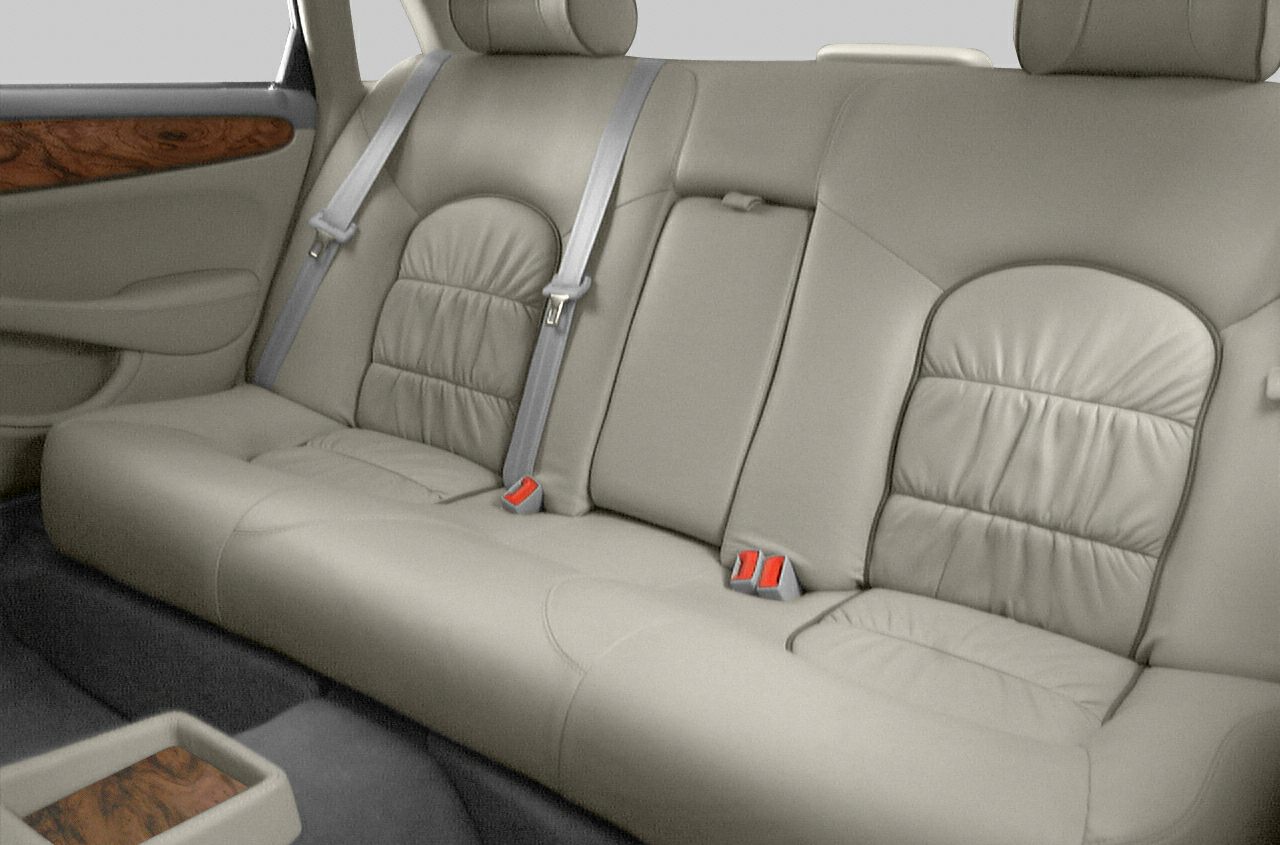 Beige leather rear seats with wood trim and seat belts