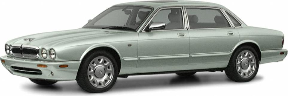 Luxury sedan with classic round headlights and smooth silver body.