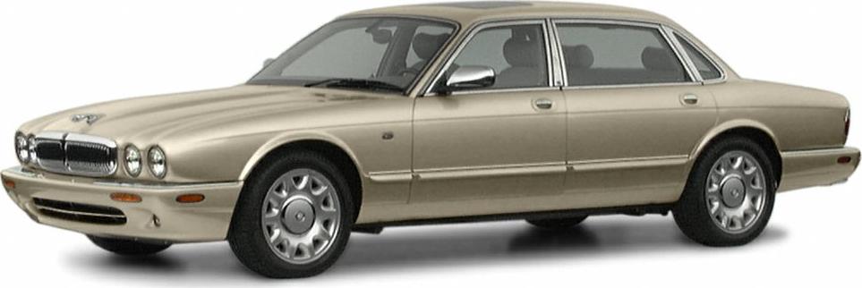 Luxury sedan with quad round headlights and chrome grille in elegant profile.