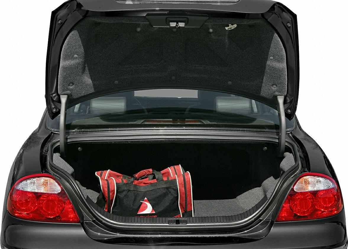Open car trunk with red and black duffel bag
