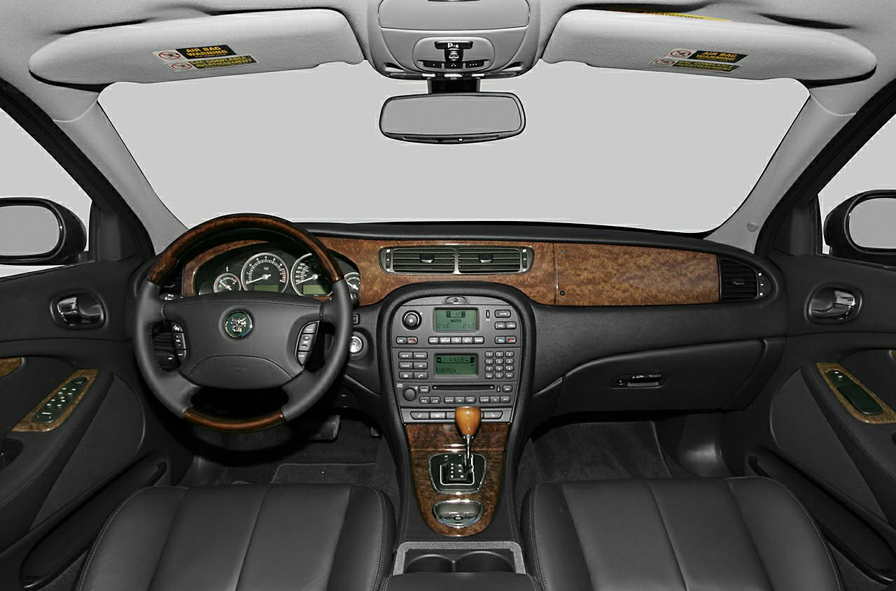 Wooden trim dashboard and leather seats in a car interior