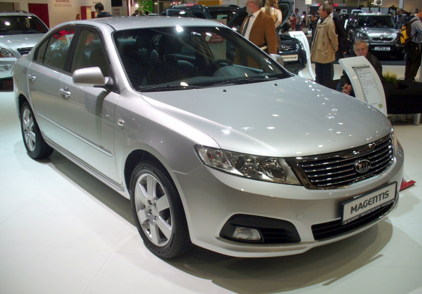 Silver midsize sedan with chrome grille and prominent headlights