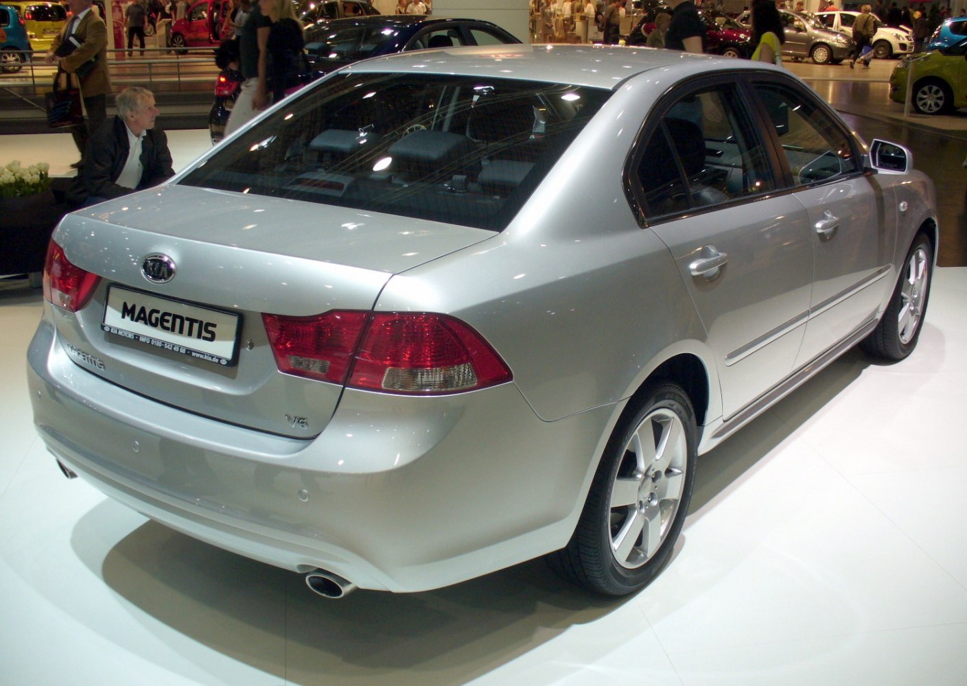 Rear view of silver sedan with V6 badge and alloy wheels.