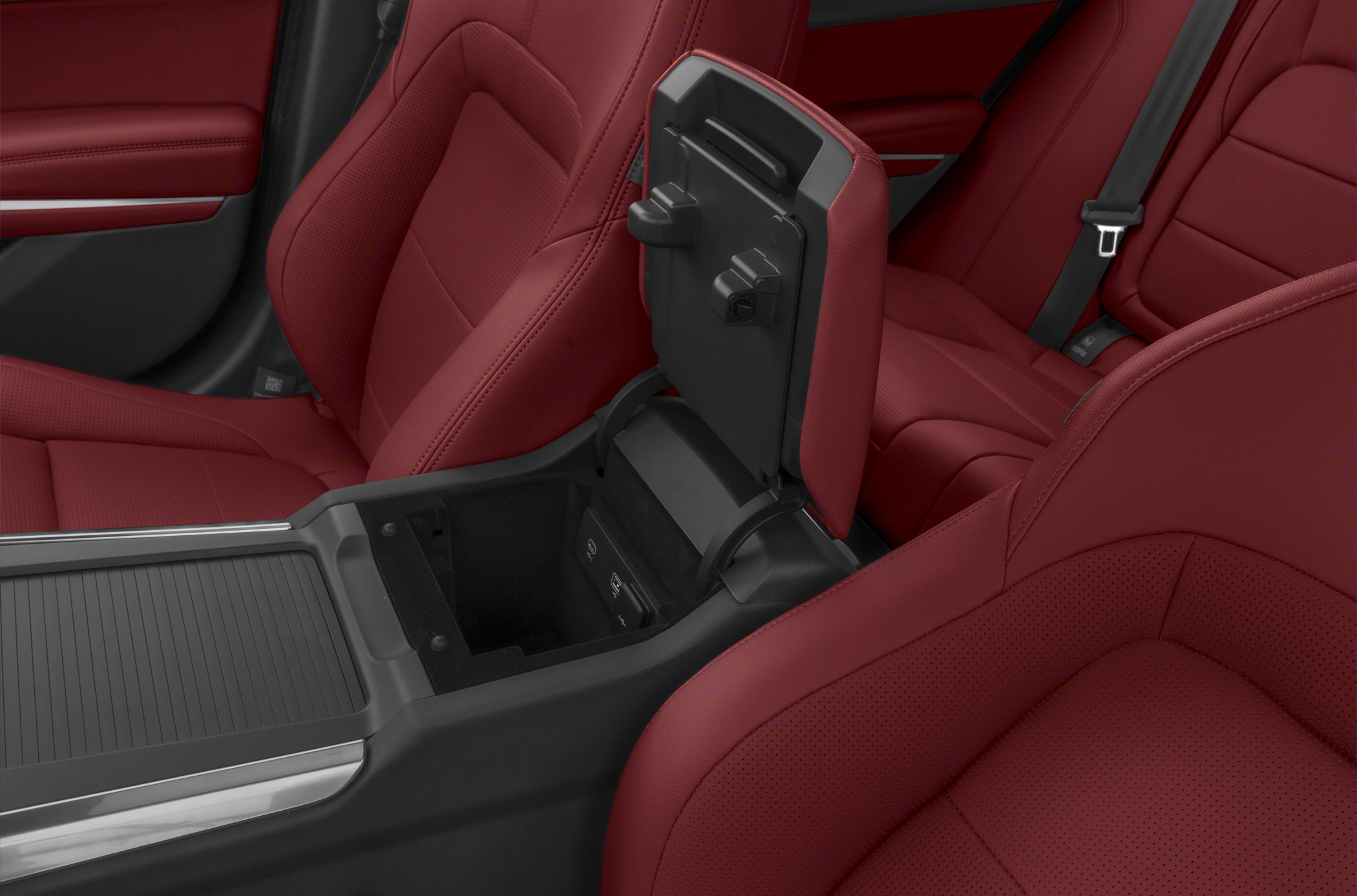 Red leather seats and open center console storage compartment.