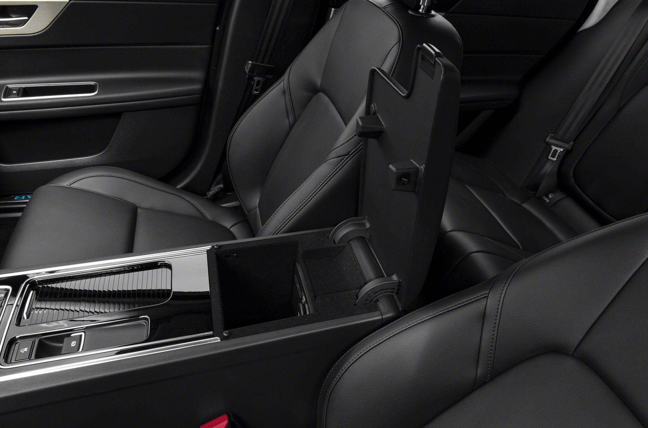 Center console with open armrest storage and black leather seats