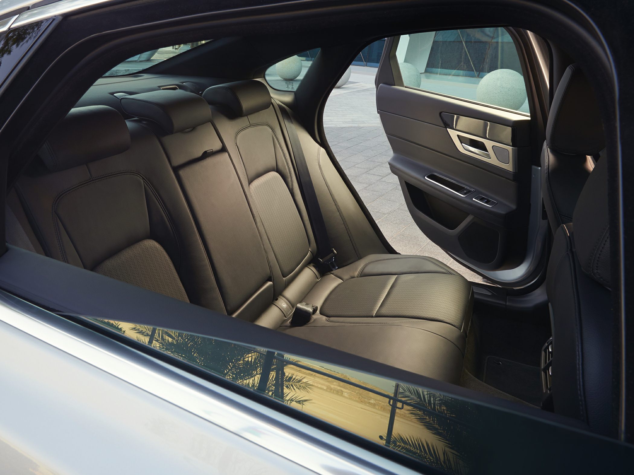 Luxury leather rear seats with modern door panel design.