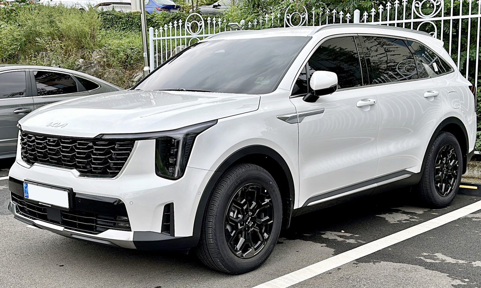 White SUV with black grille, vertical LED headlights, and black alloy wheels