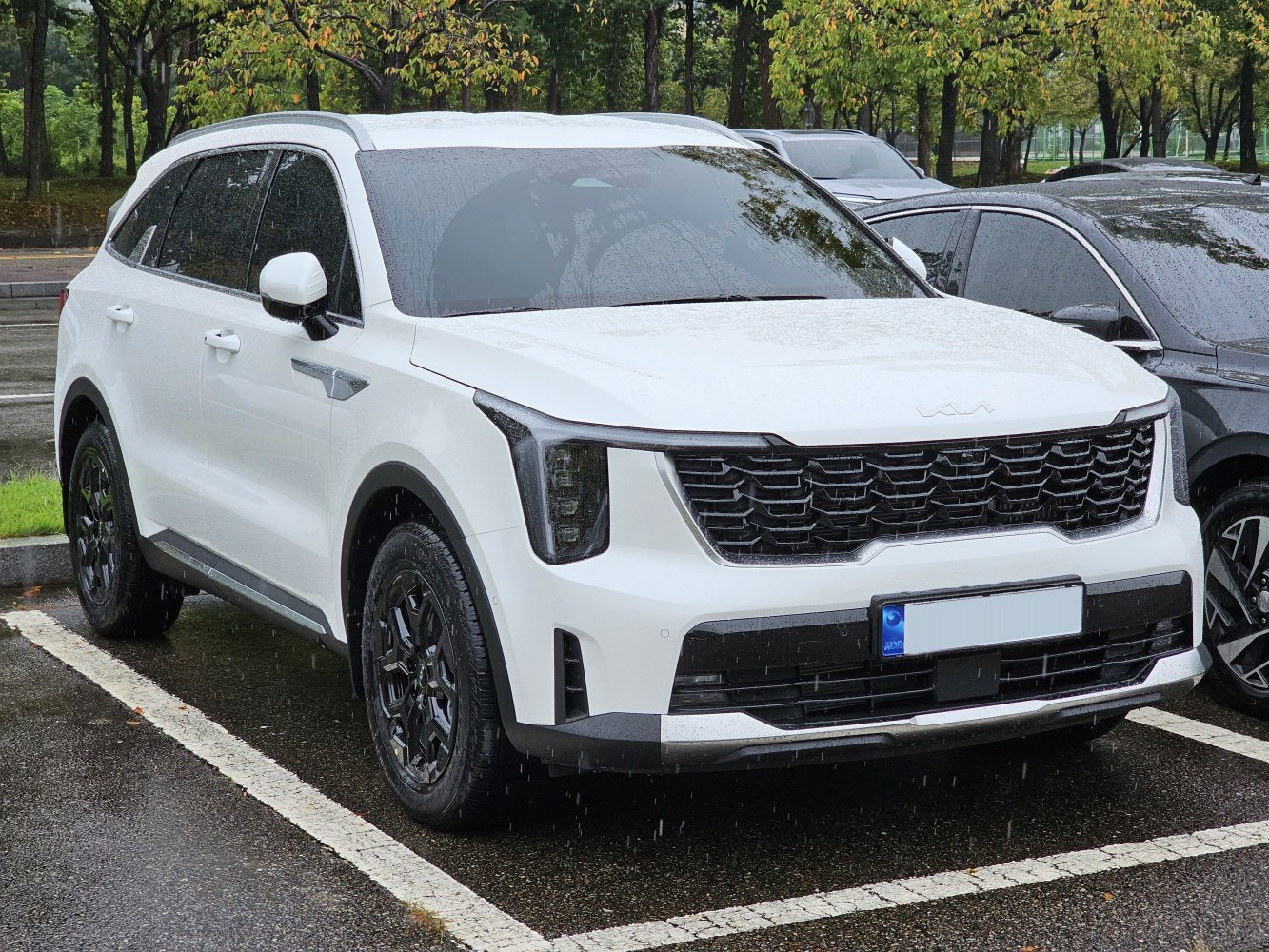 Bold front grille and vertical headlights of a modern SUV in white