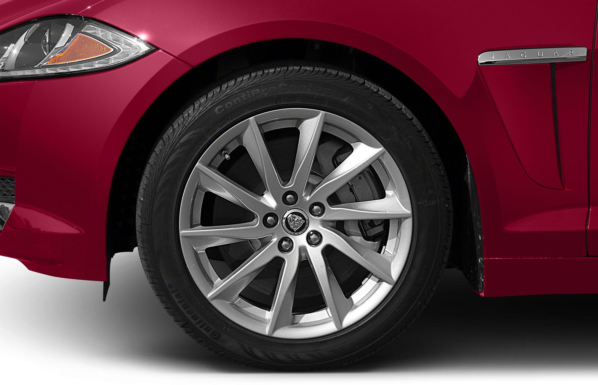 Alloy wheel and front fender detail with Jaguar badge
