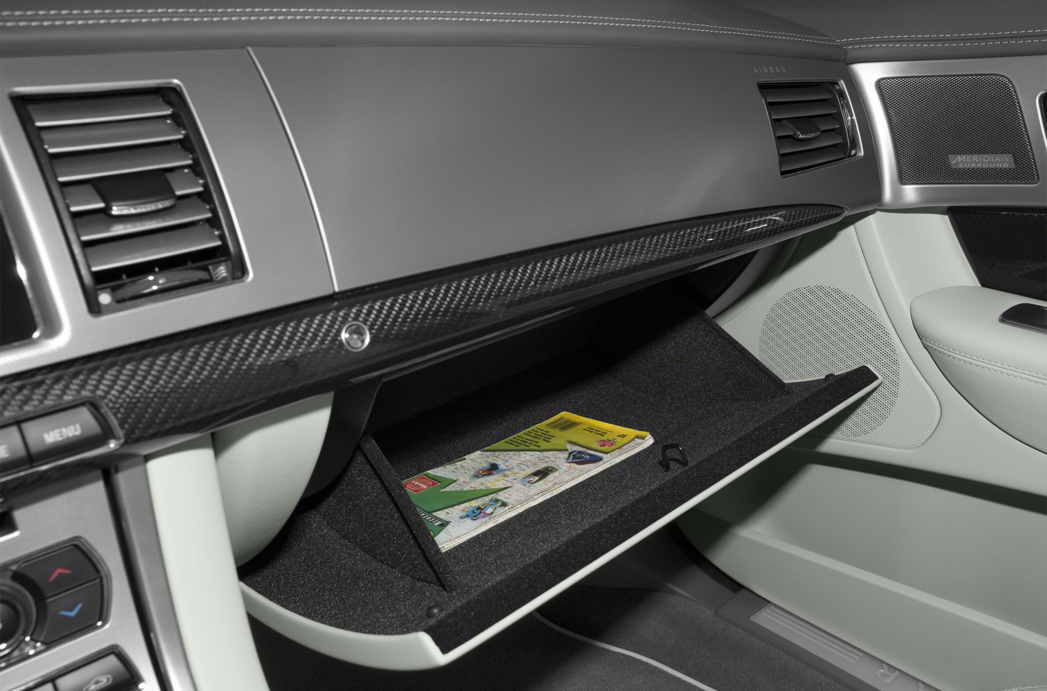 Open glovebox with carbon fiber dashboard trim and air vents