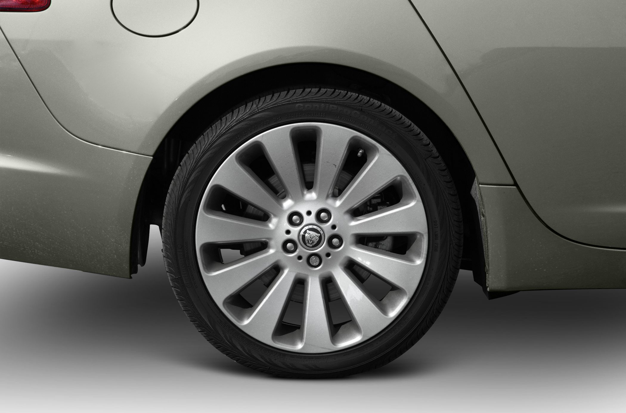 Rear alloy wheel and fuel door on a silver sedan