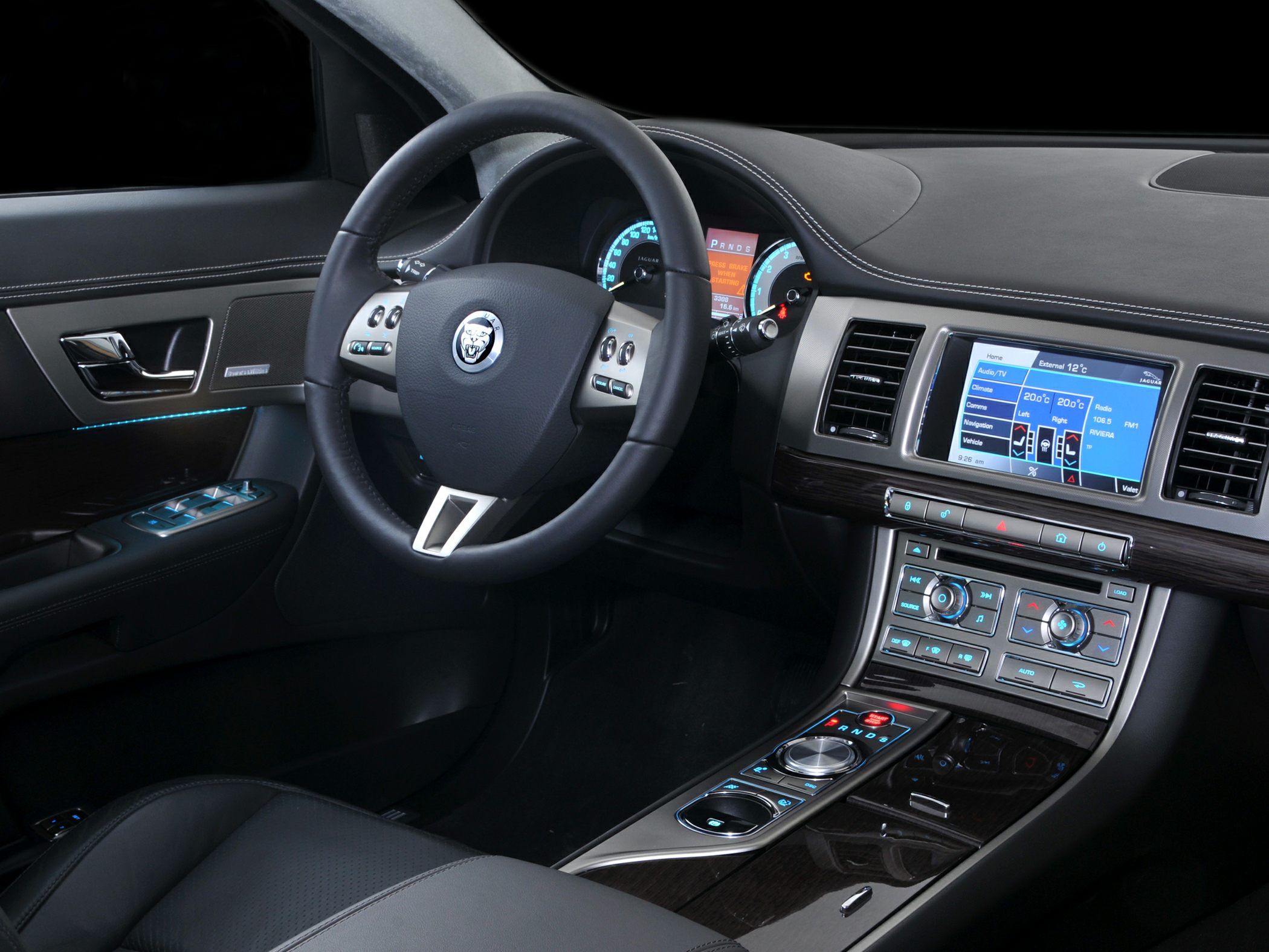 Luxury car interior with dashboard, steering wheel, and infotainment system