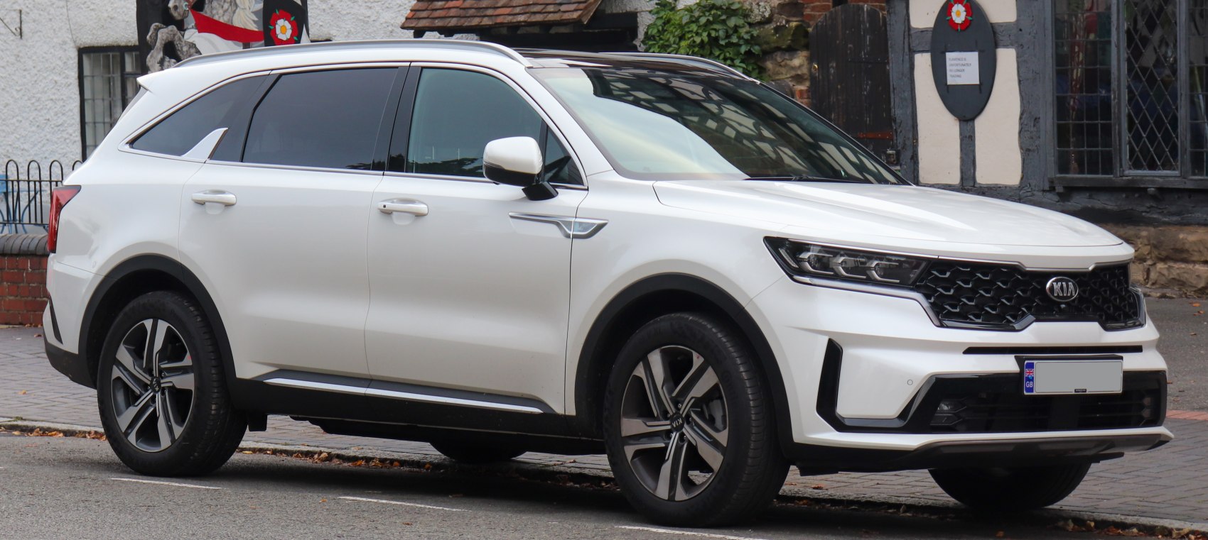 Front side view of a sleek white SUV with LED headlights and alloy wheels