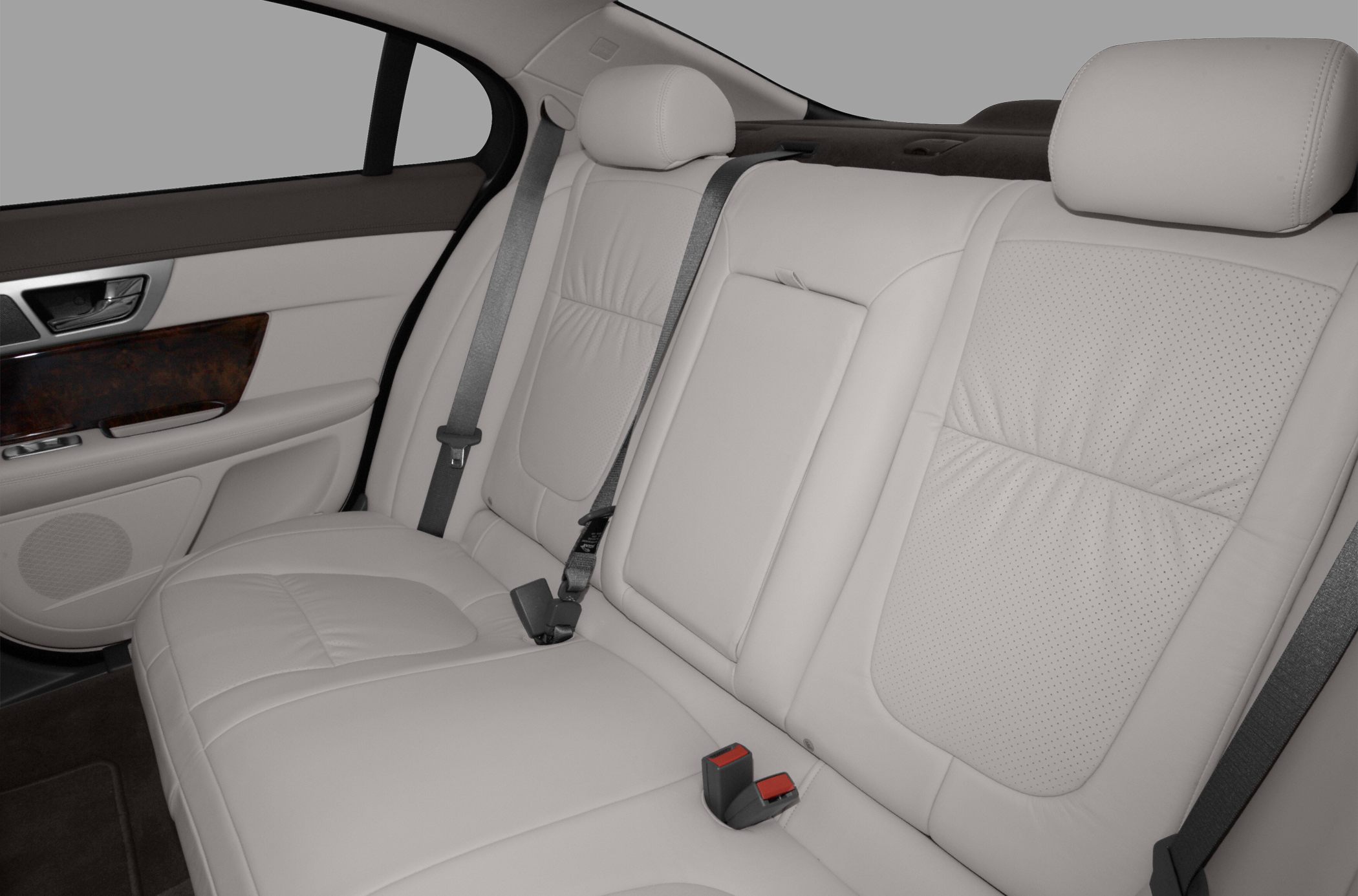 Leather rear seat with wood trim, seat belts, and headrests