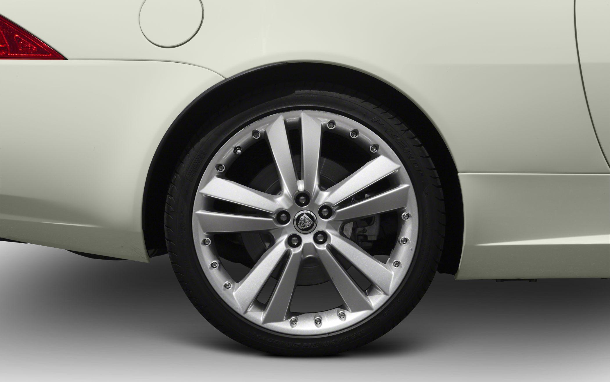 Close-up of silver alloy wheel rim and rear wheel arch.
