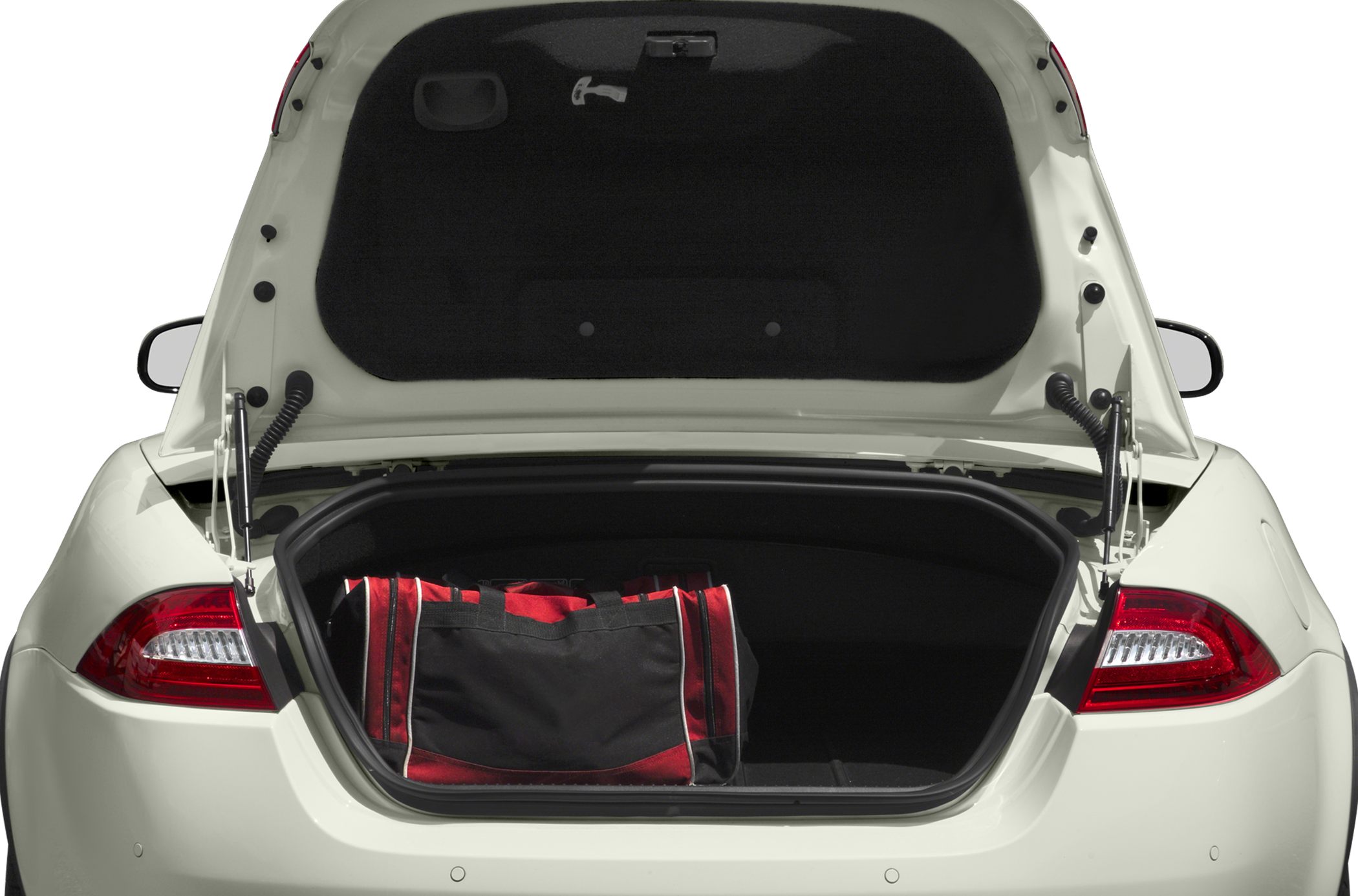 Open trunk of a convertible with a black and red bag inside