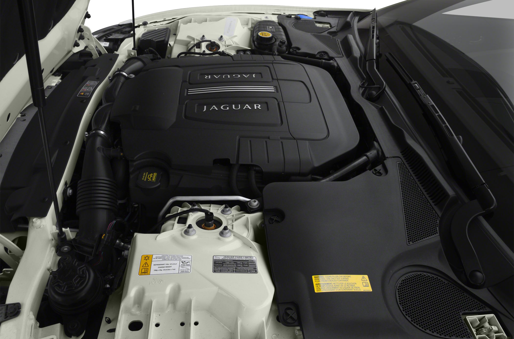 Engine bay with Jaguar-branded engine cover and car components