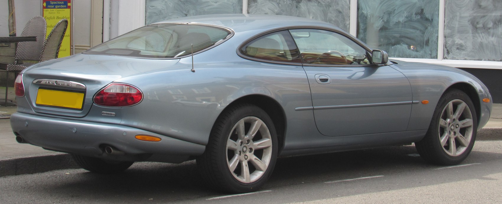 Rear side view of sleek sports coupe with alloy wheels and smooth body lines