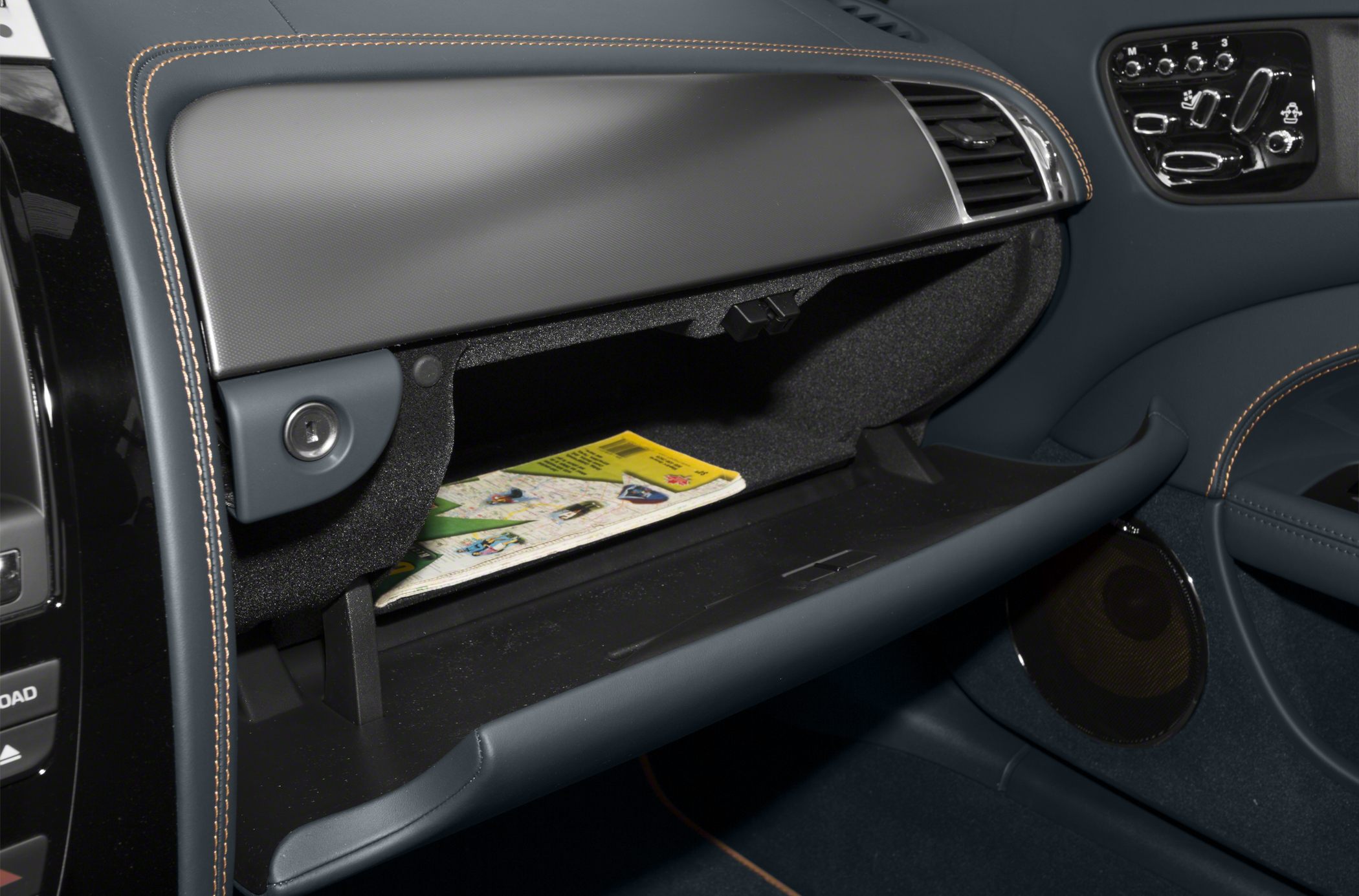 Open glovebox with visible map and stitched dashboard interior