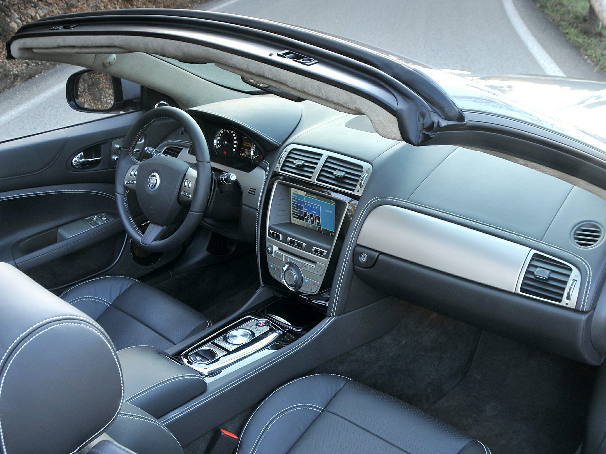 Luxury convertible interior with leather seats and advanced dashboard