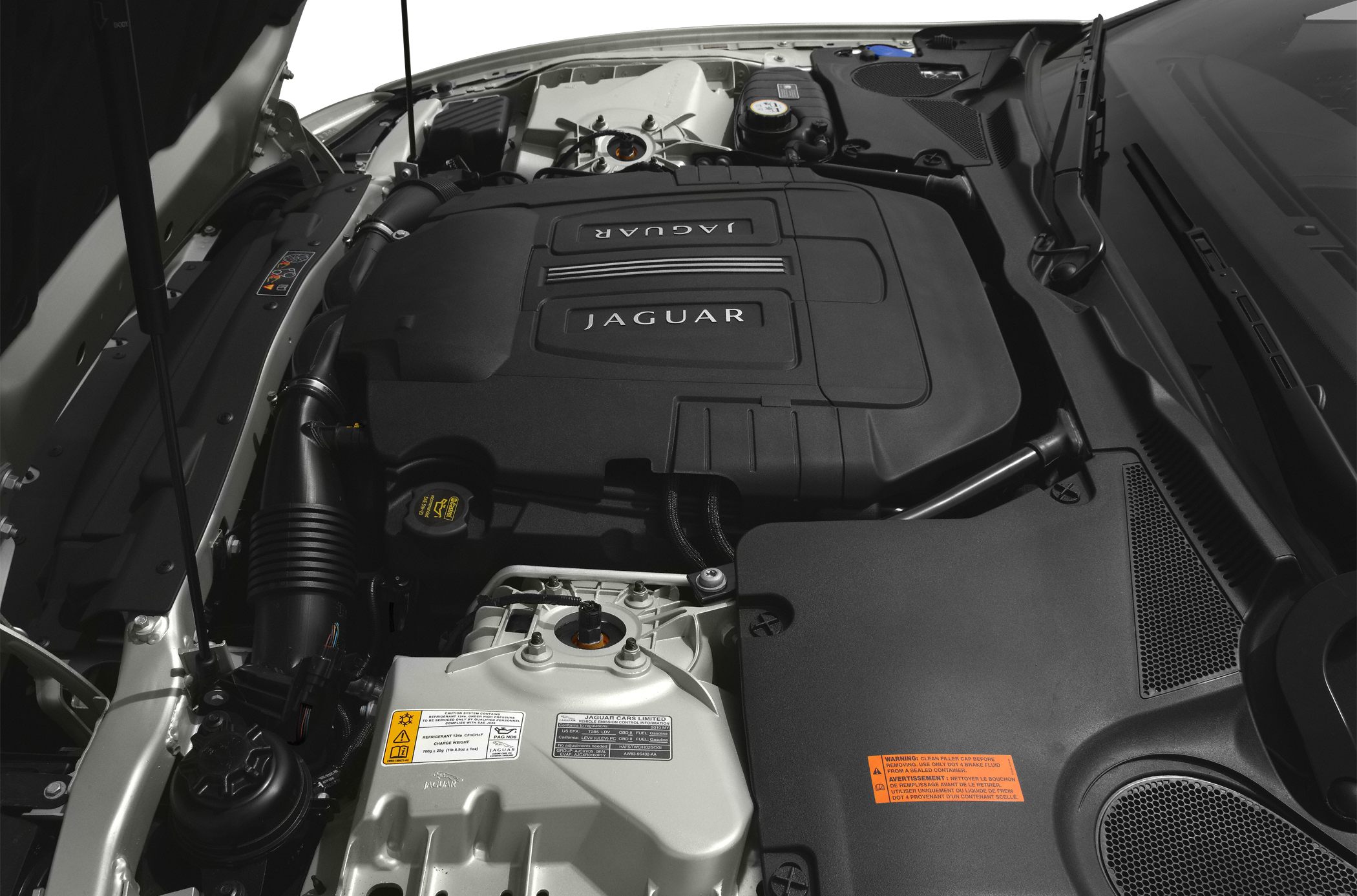 Close-up of an engine bay with Jaguar branded engine cover