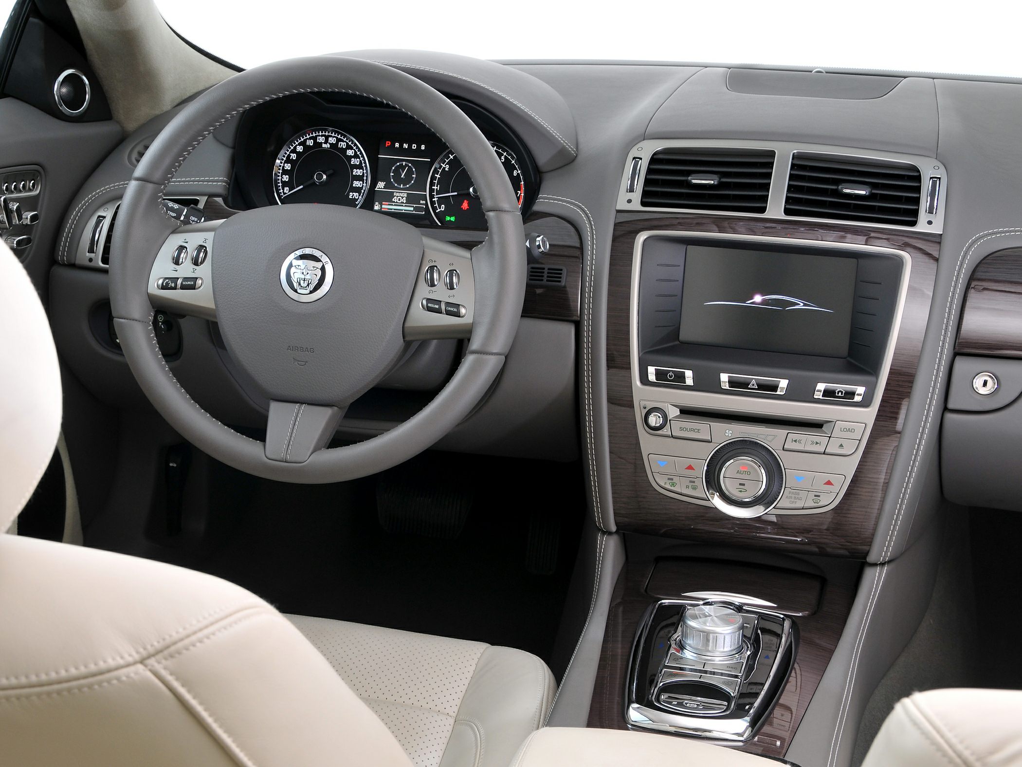 Luxury interior with steering wheel, dashboard, infotainment, wood trim