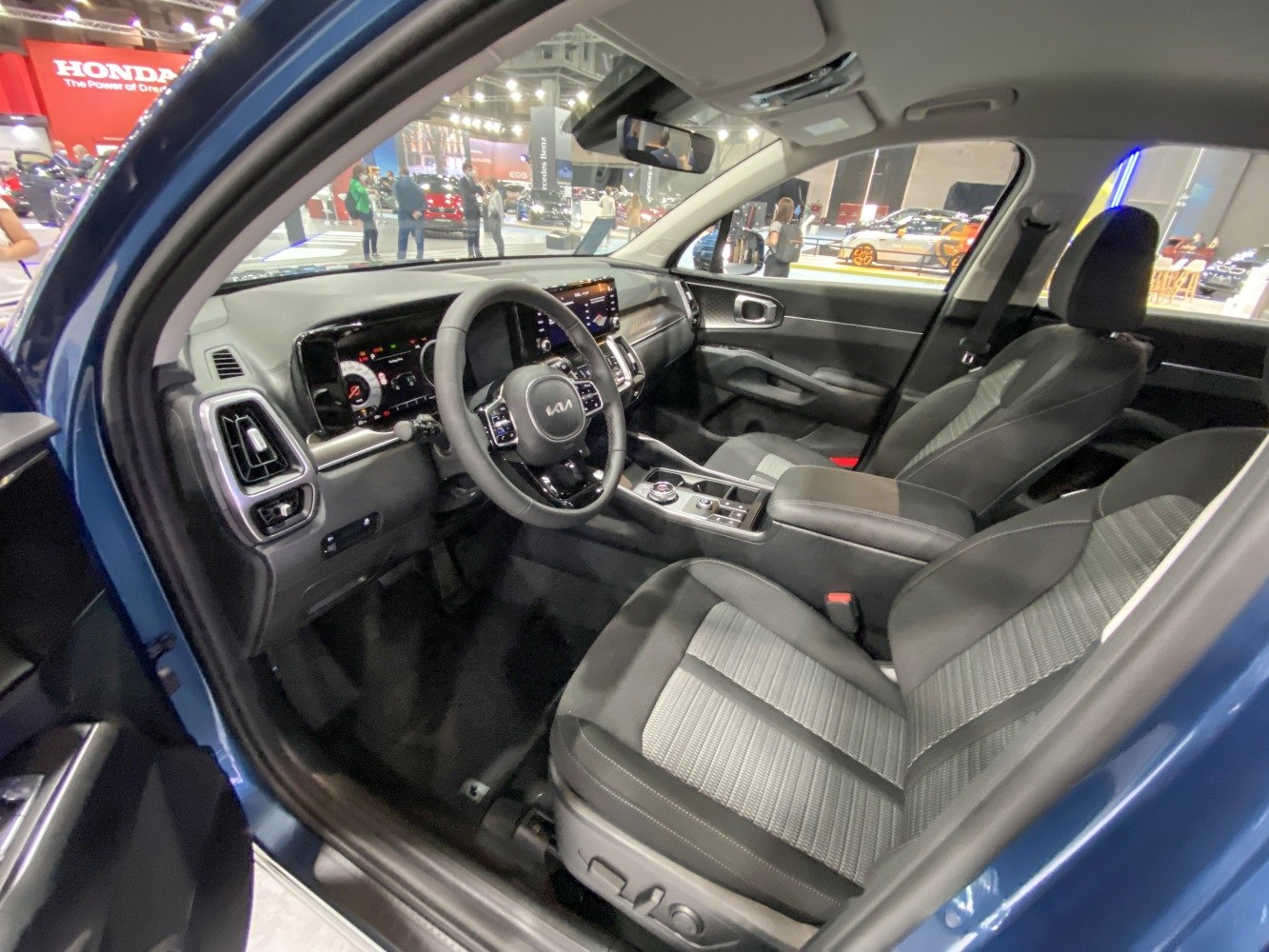 Digital dashboard and ergonomic front seats inside a modern vehicle.