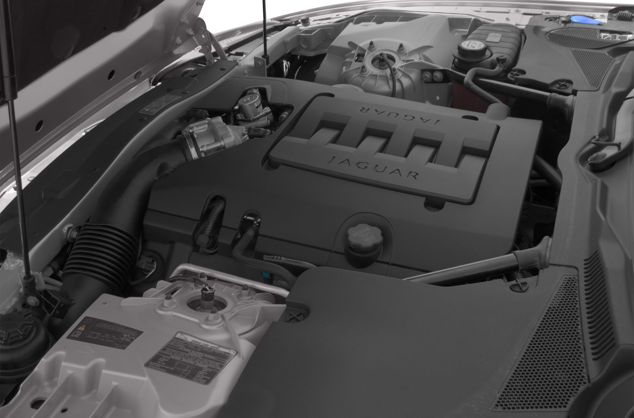 Engine bay with Jaguar branded engine cover and surrounding components
