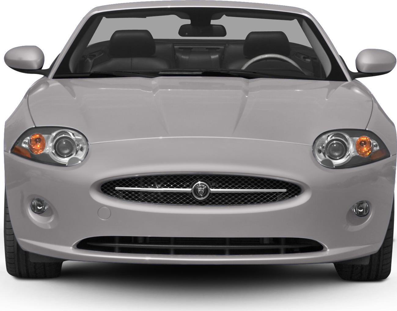 Front view showing round headlights and mesh grille with badge.