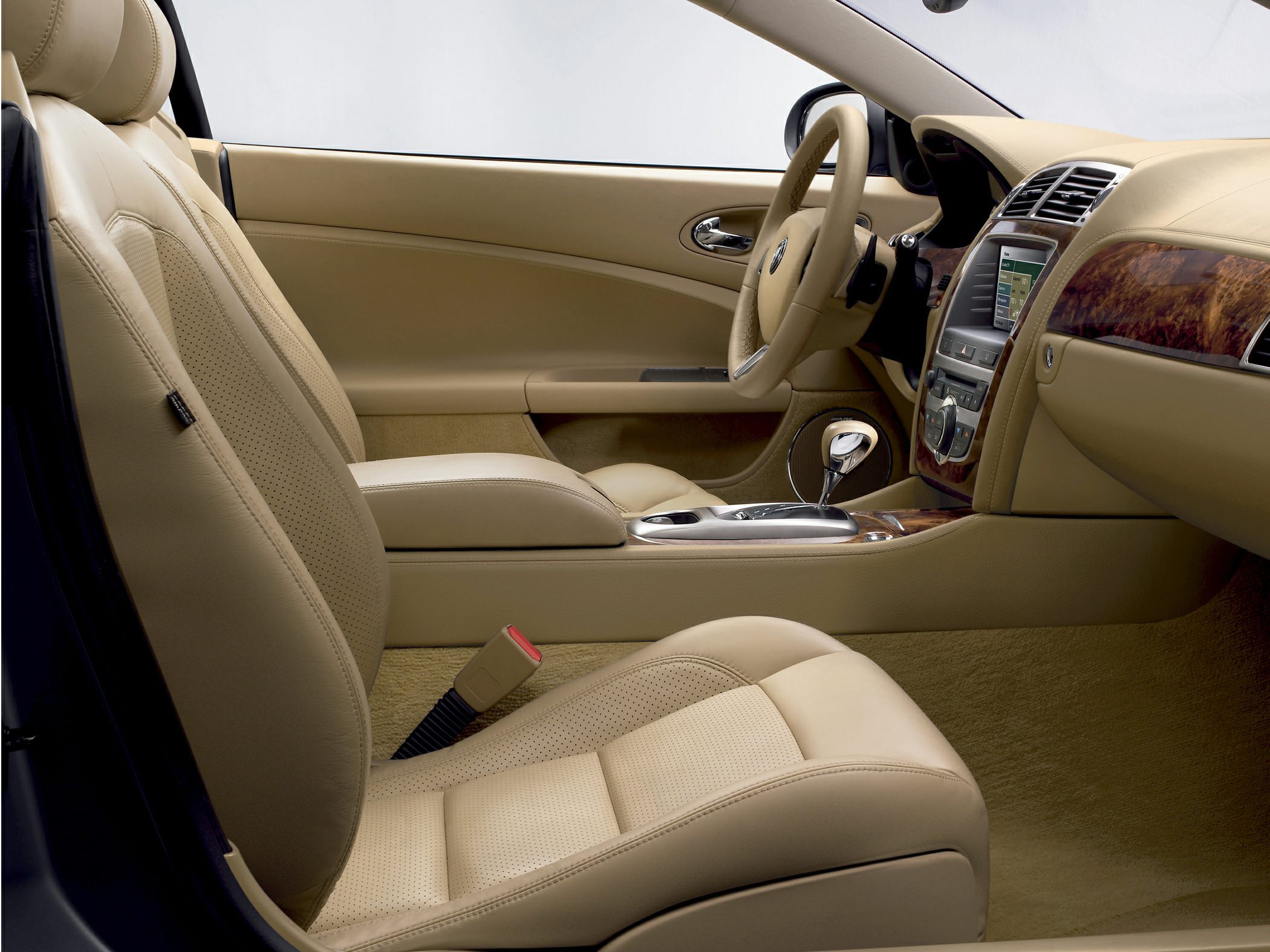 Beige leather seats and wood trim luxury interior with automatic gear shift