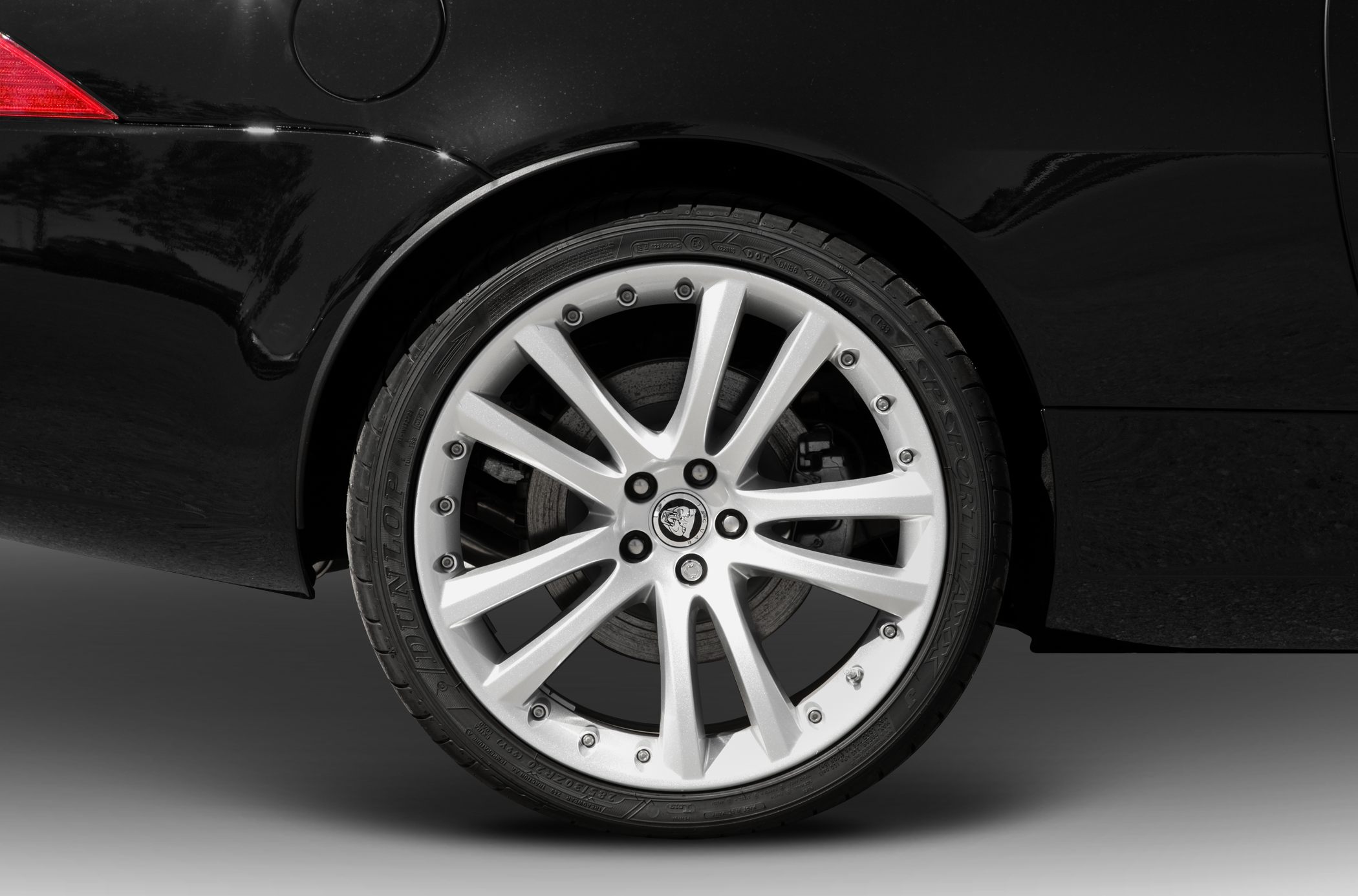 Silver multi-spoke alloy wheel with tire and brake disc