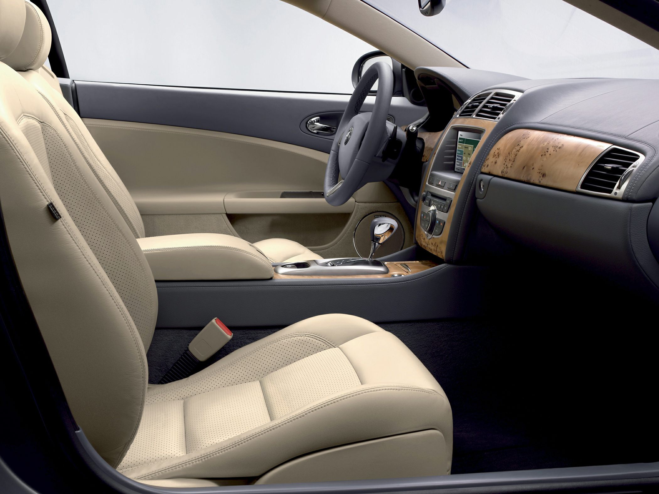Luxurious beige leather seats and wood trim dashboard with automatic gear shift.