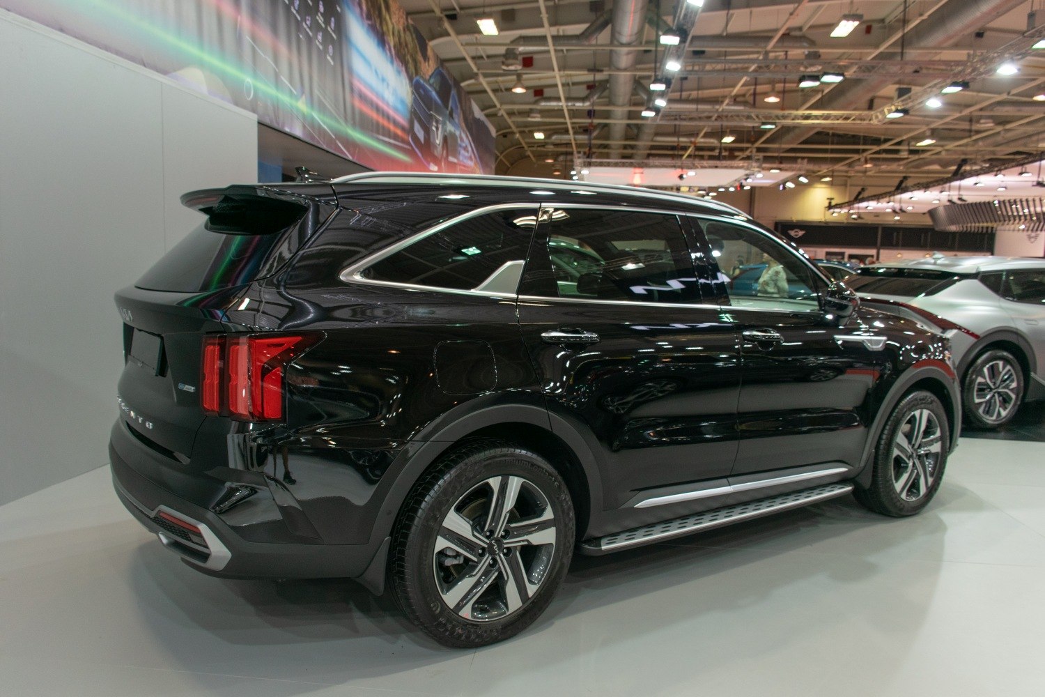 Rear side view of black SUV with distinctive tail lights and alloy wheels