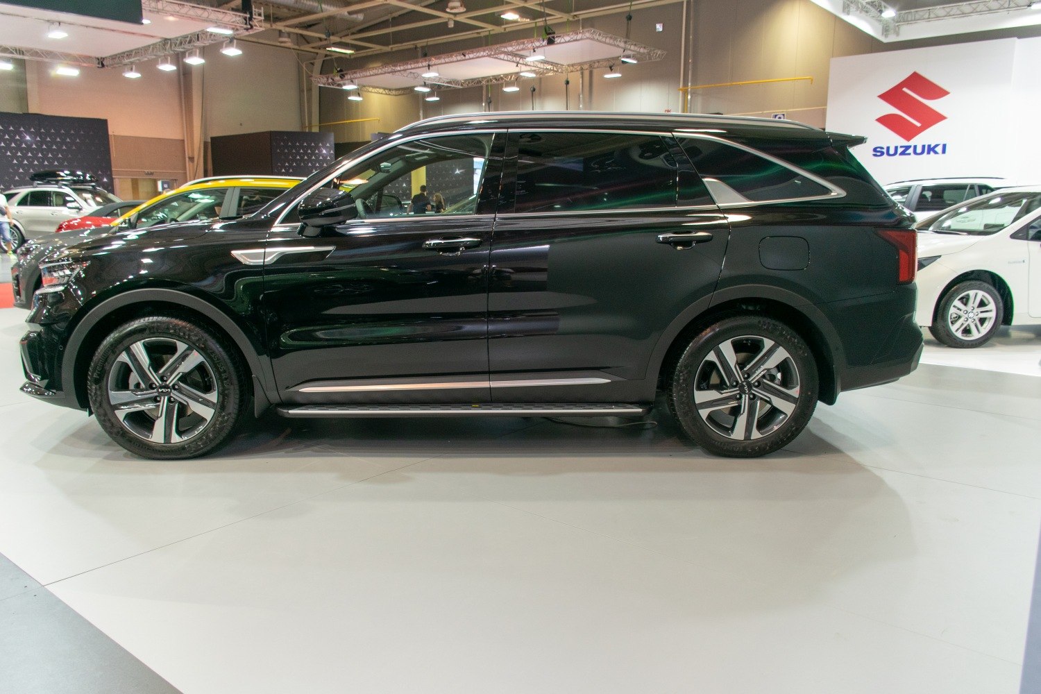 Black SUV side view with alloy wheels and roof rails