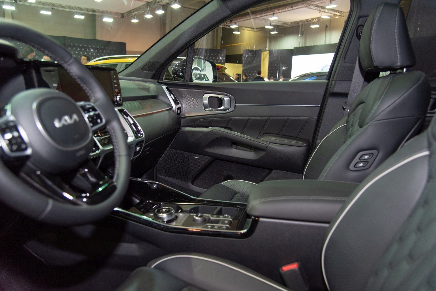 Modern car interior with touchscreen, steering wheel, and premium upholstery