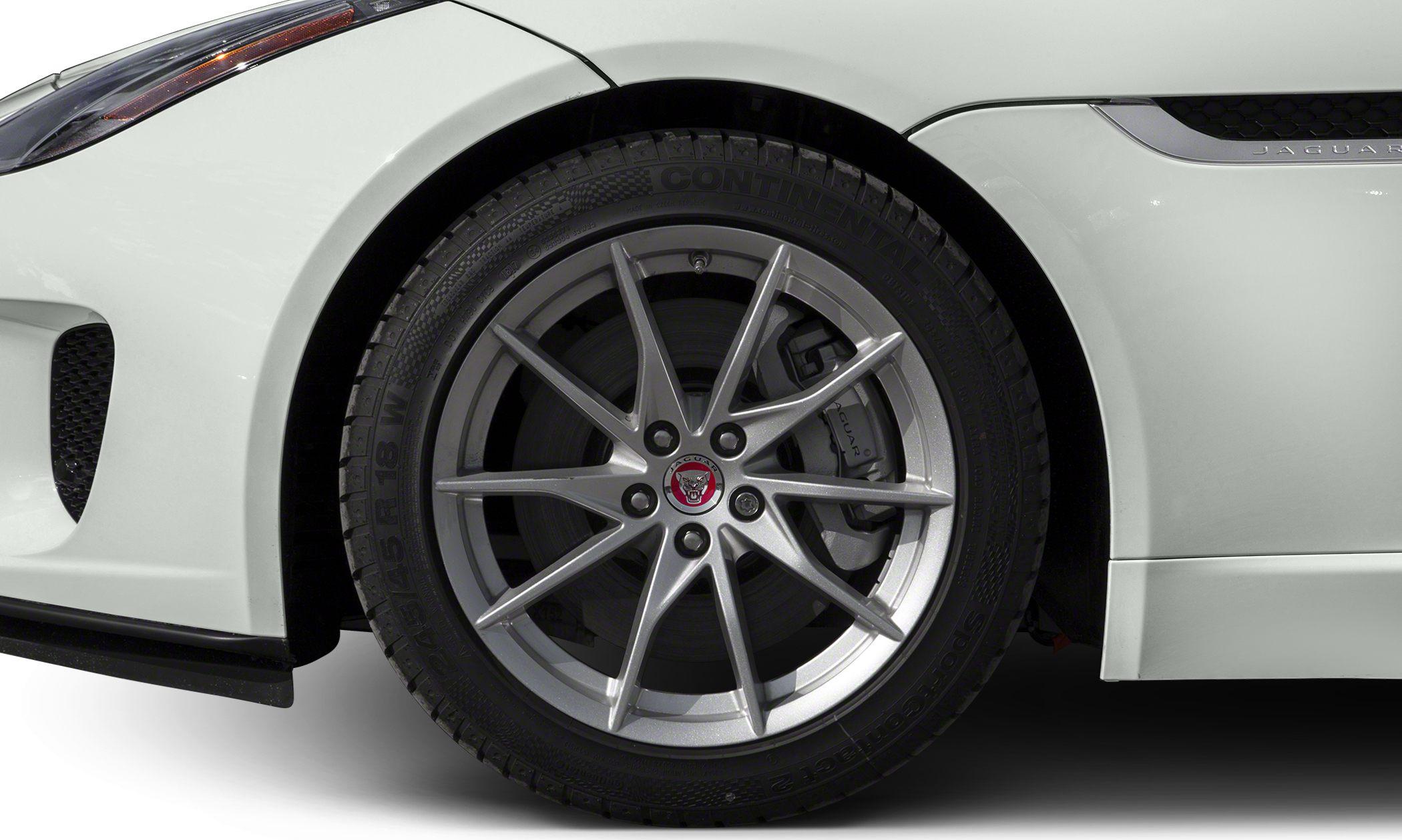 Close-up of alloy wheel with performance brake caliper and Continental tire tread.