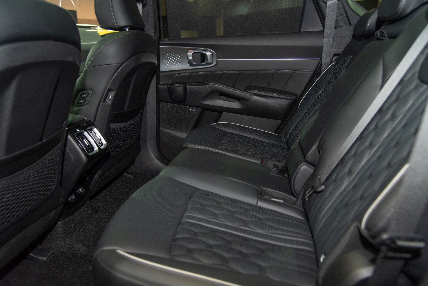 Black leather rear seats with door panel and air vents interior view