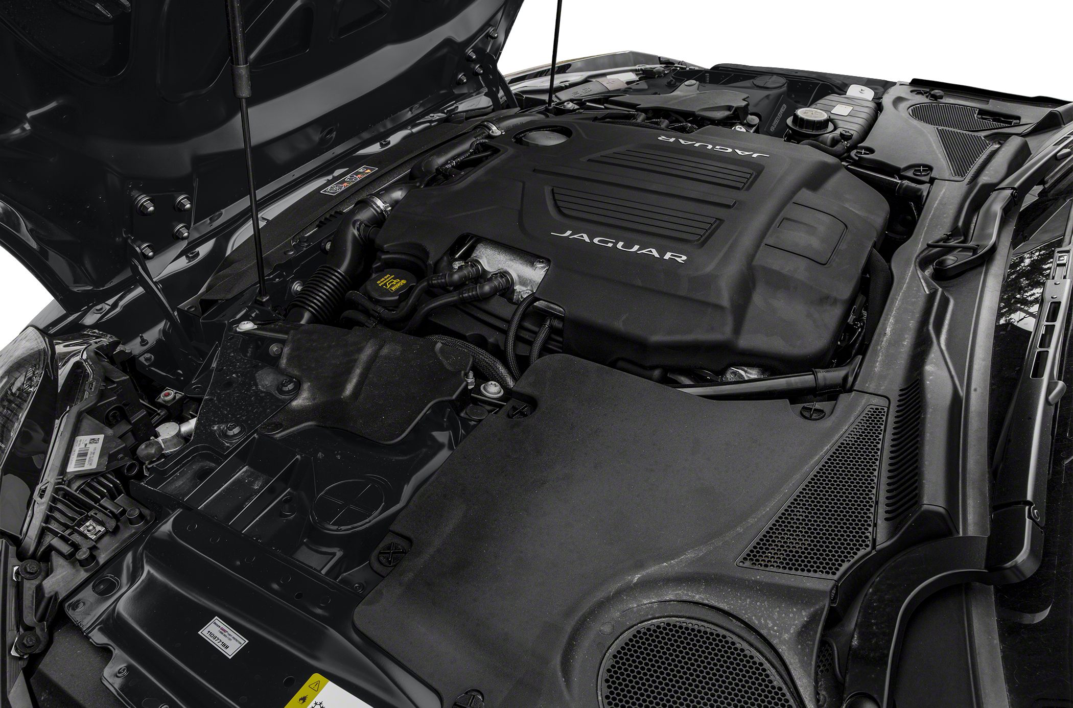 Closeup of a modern sports car engine bay with visible engine cover.
