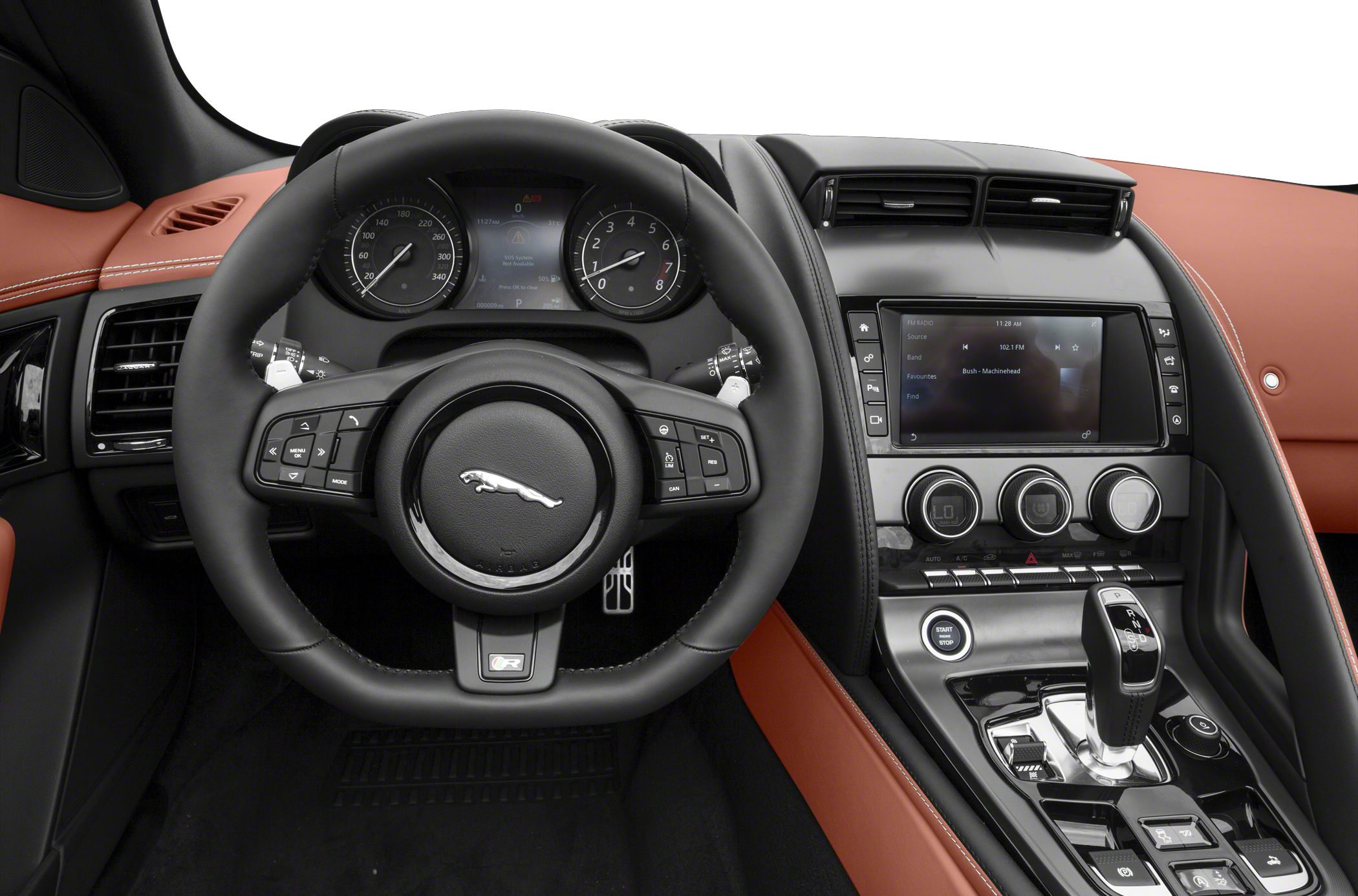 Steering wheel, dashboard gauges, center console with gear shifter and climate controls