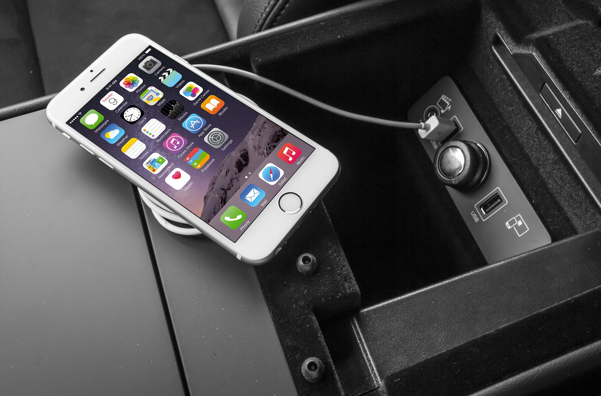 USB port and power outlet for mobile device connectivity inside a car center console