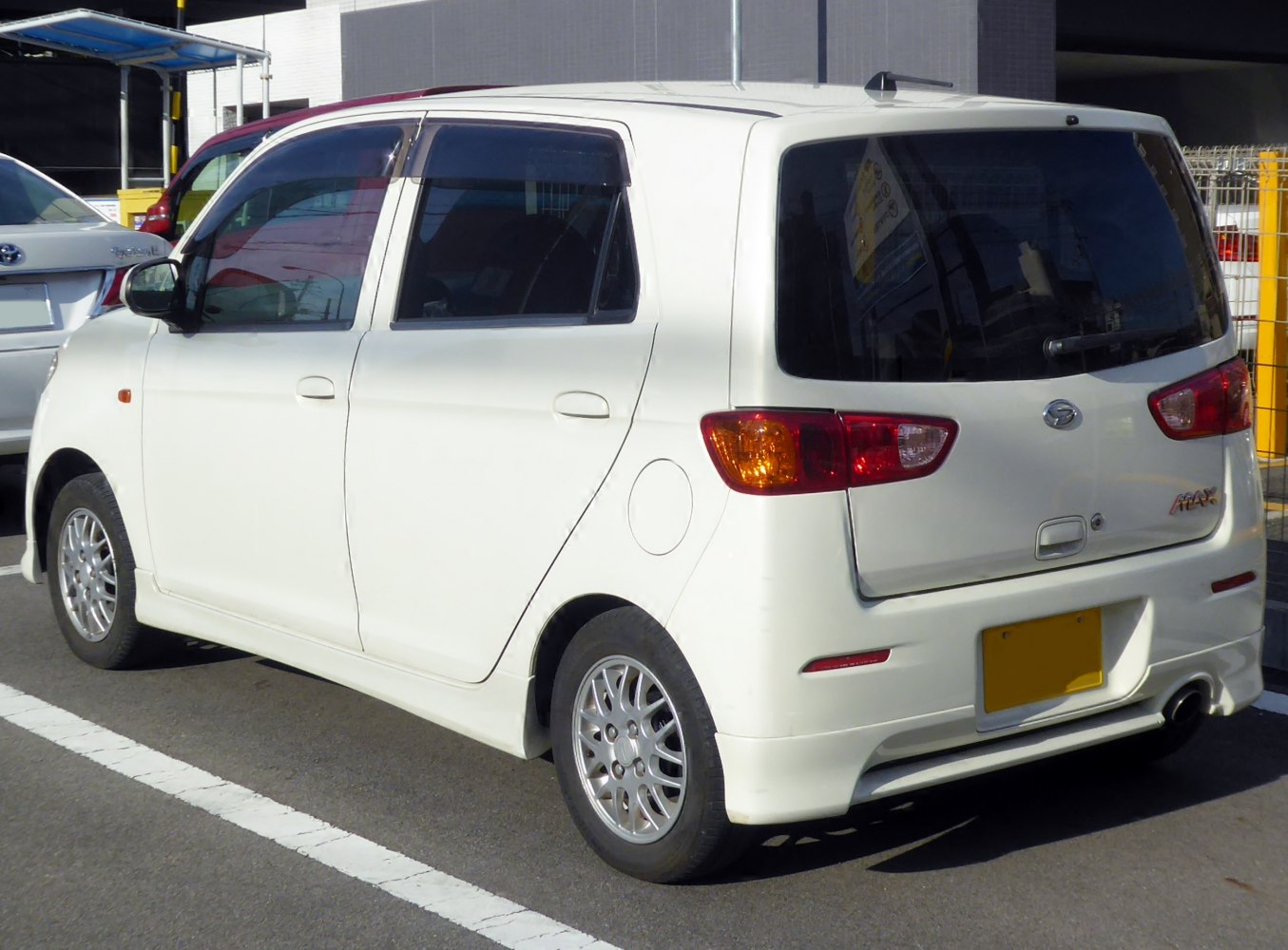 Rear side view of compact hatchback with alloy wheels and tinted windows