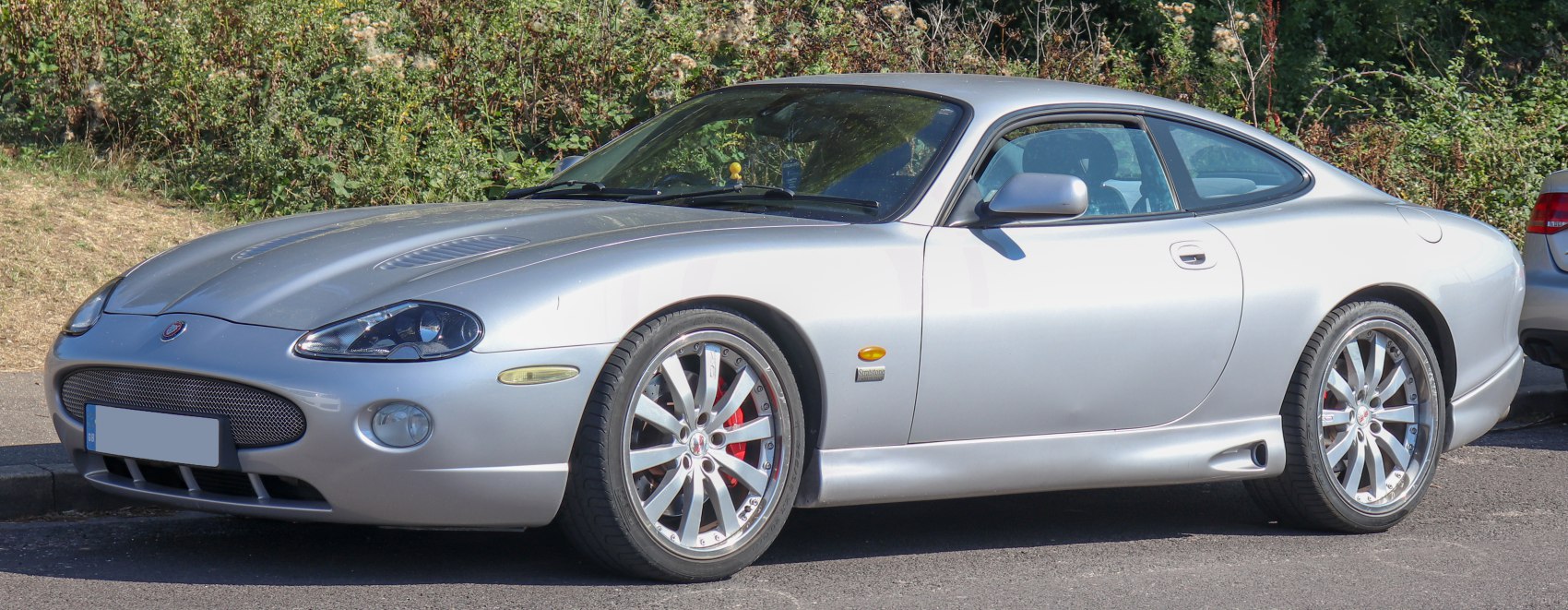 Silver sports coupe with alloy wheels and aerodynamic vents