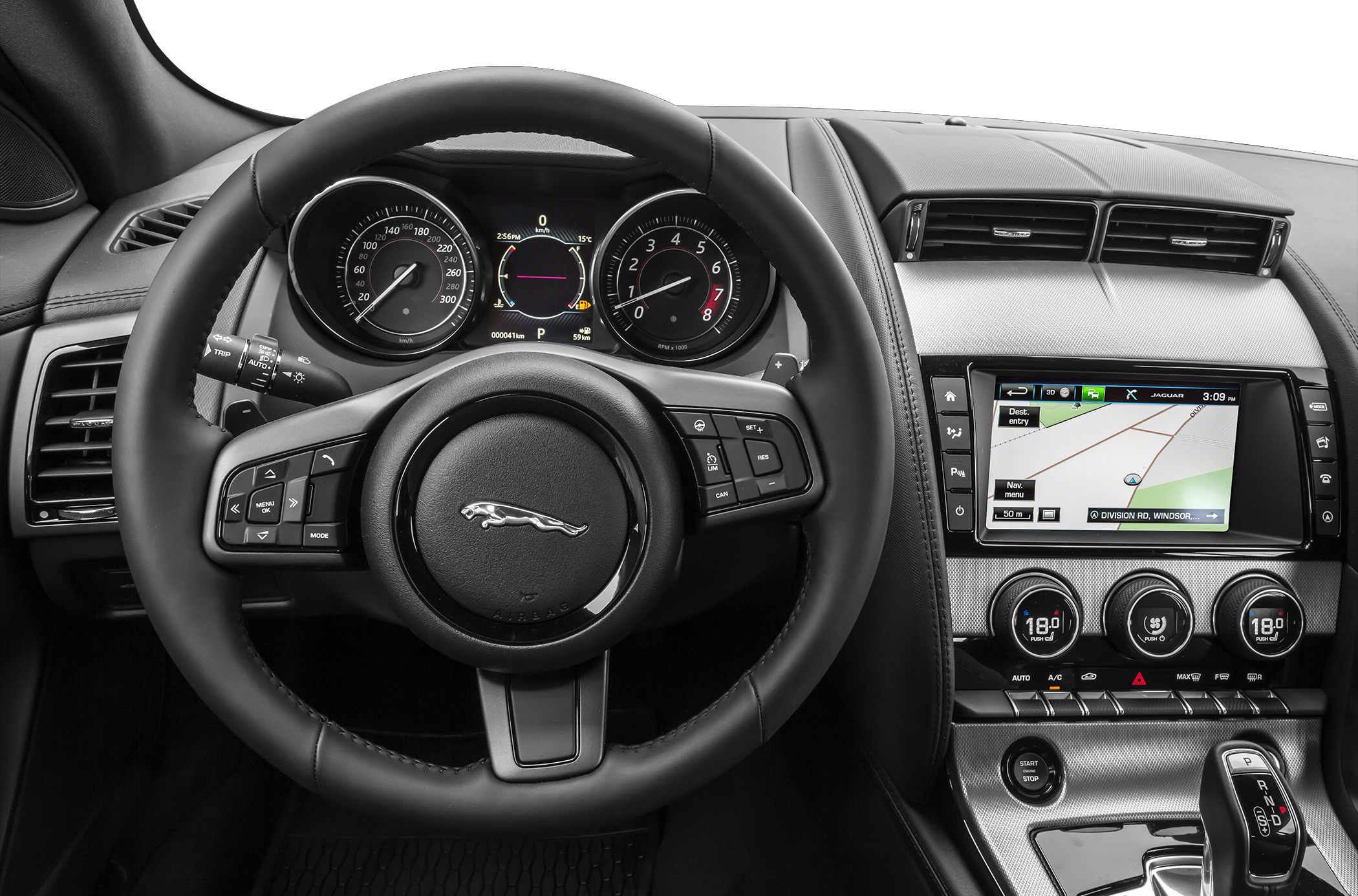Steering wheel with control buttons and dashboard with instrument cluster and infotainment screen
