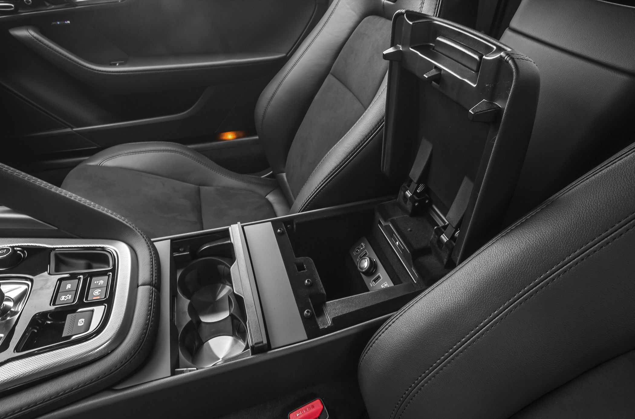 Center console with cup holders and open armrest storage compartment