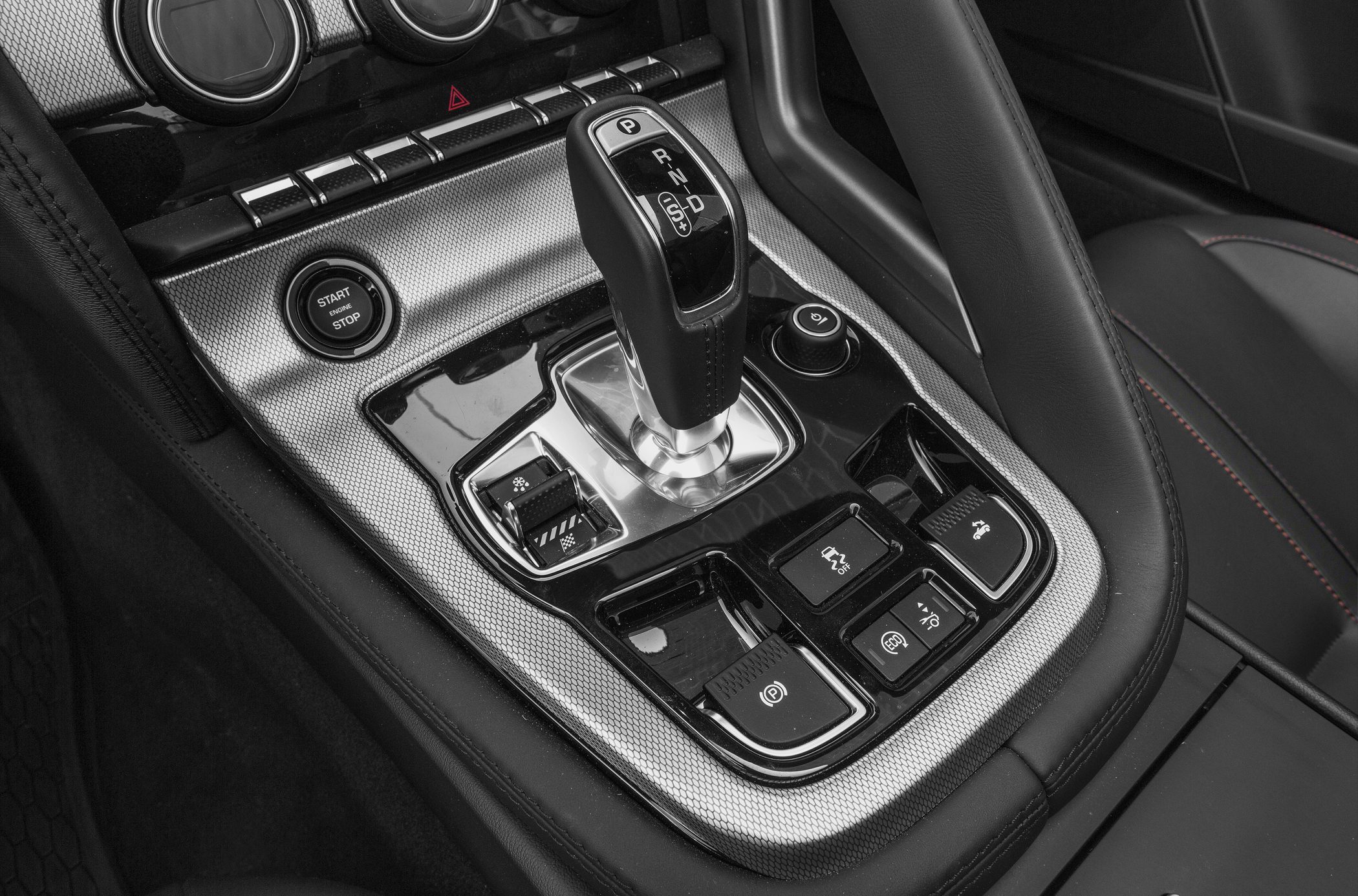 Gear shifter and control buttons in center console of luxury sports convertible