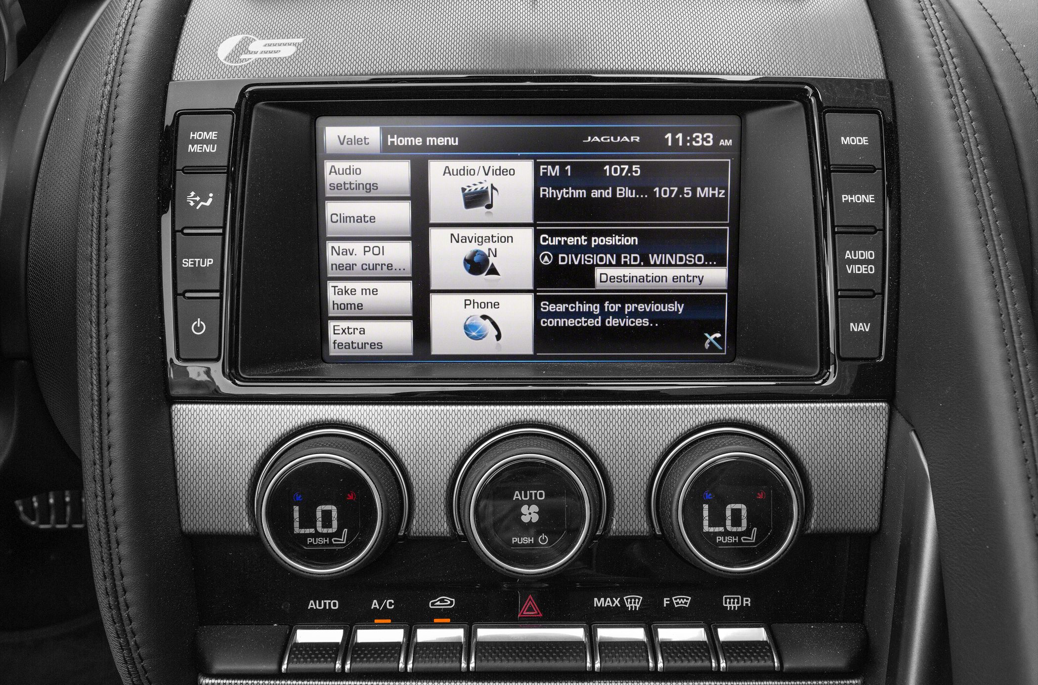 Infotainment touchscreen with navigation and dual-zone climate control knobs.