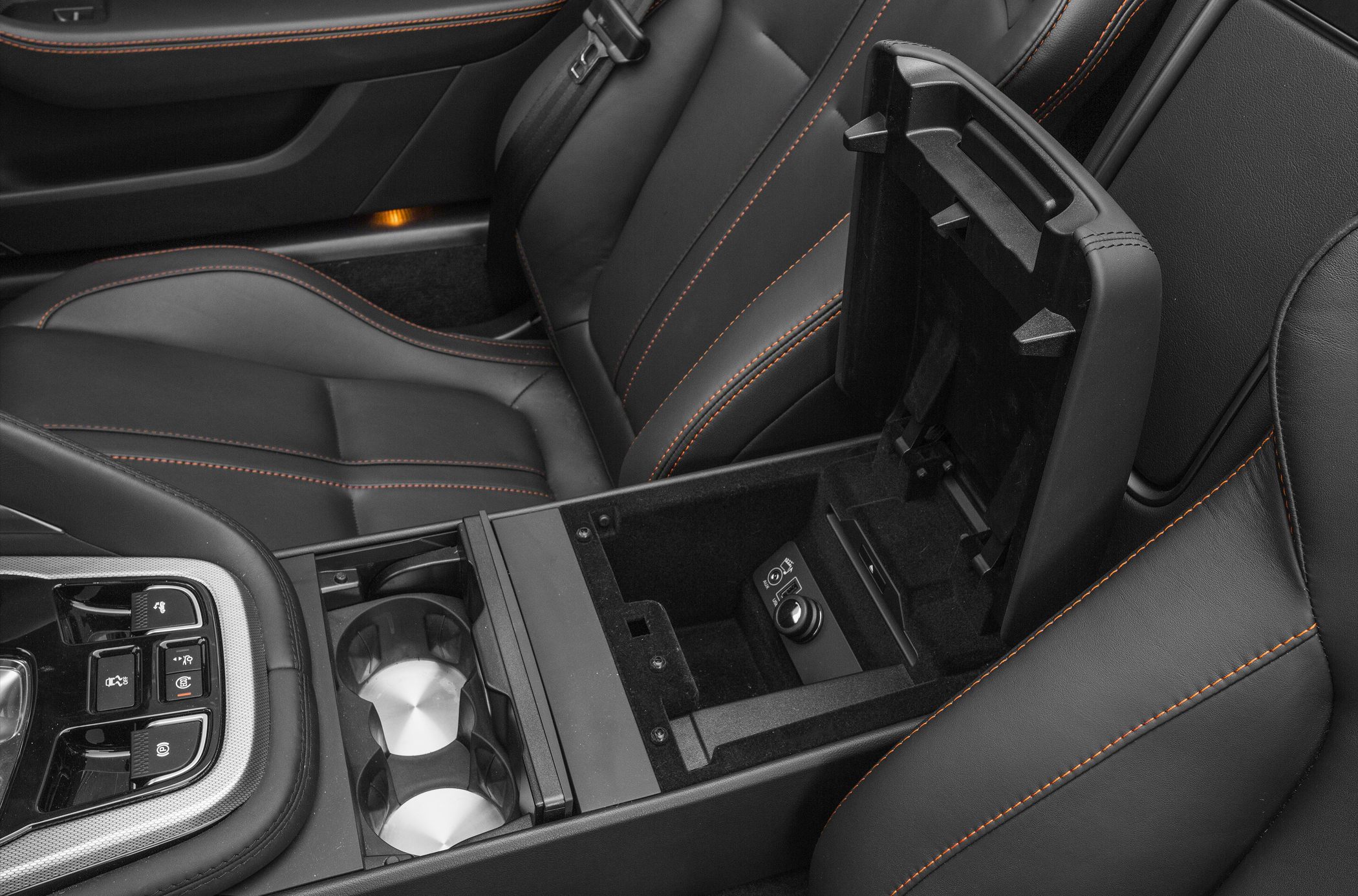 Center console with cup holders and storage compartment in a car interior