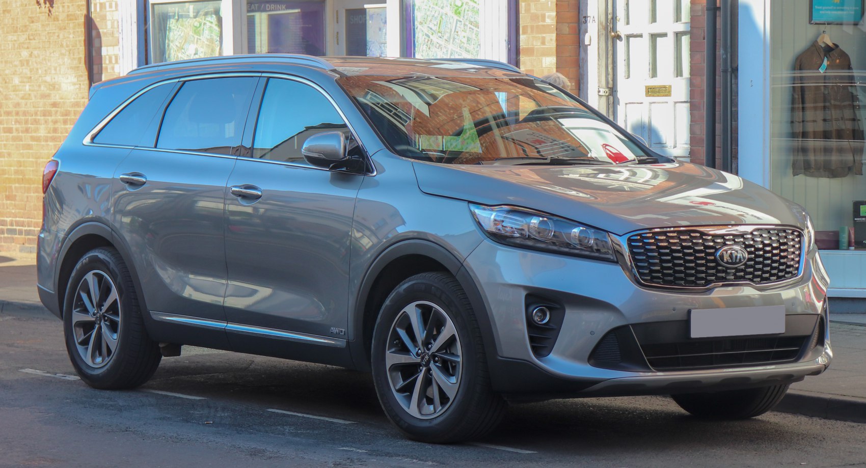 Front side view of SUV with distinctive headlights and alloy wheels