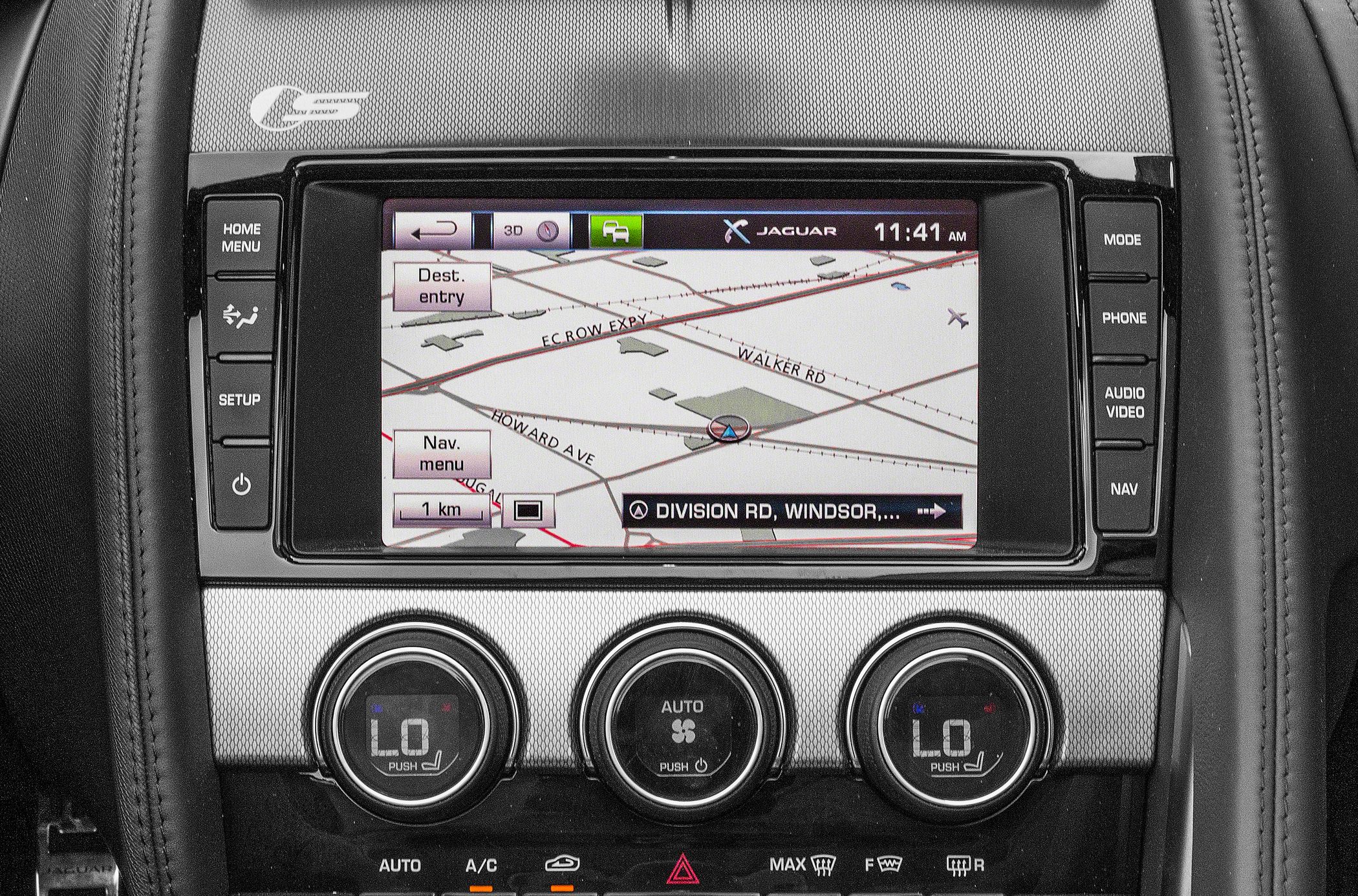 Navigation screen with map display and dual-zone climate control knobs