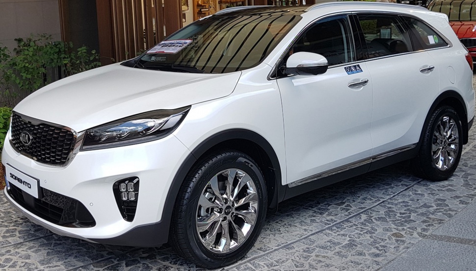 White SUV front side view with LED headlamps and chrome alloy wheels